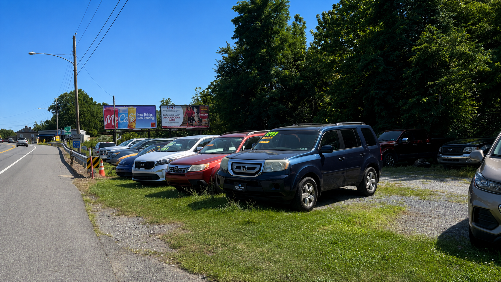 Roadside vehicle display showcasing affordable cars at JF Auto Sales in Leesport