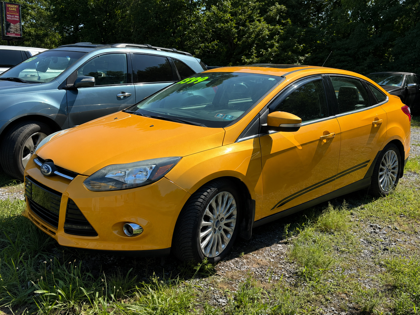 Front view of a reliable red sedan for sale on the JF Auto Sales lot