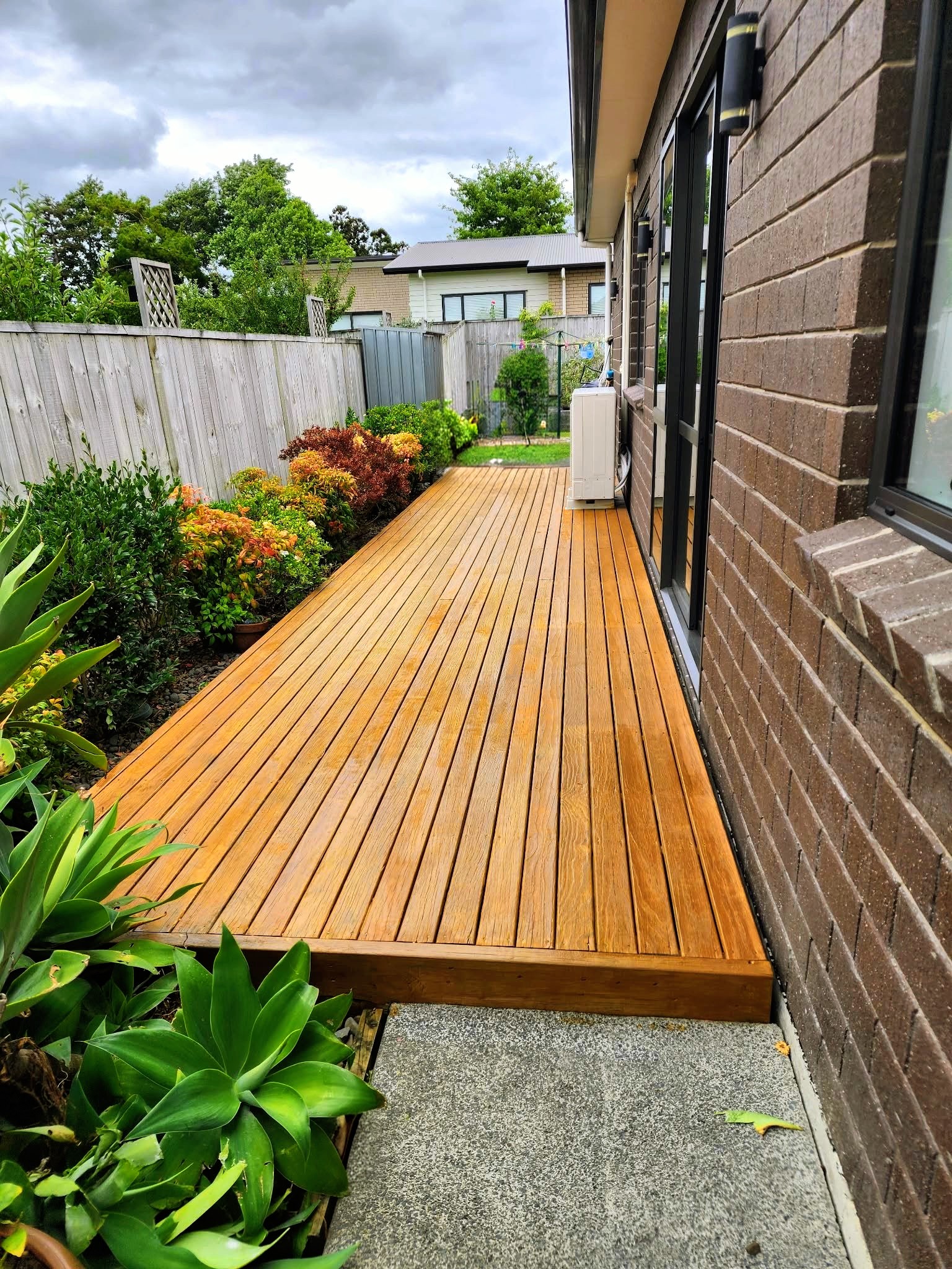Lush garden makeover with layered flowerbeds, mature shrubs, and vibrant seasonal plantings