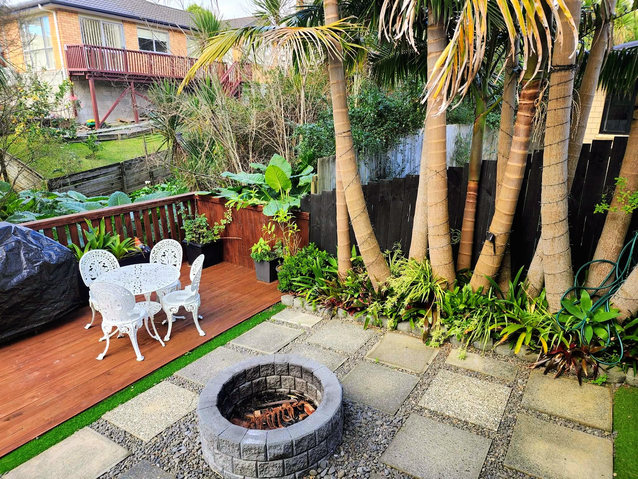 Driveway landscaping with feature planting, decorative gravel borders, and architectural shrubs
