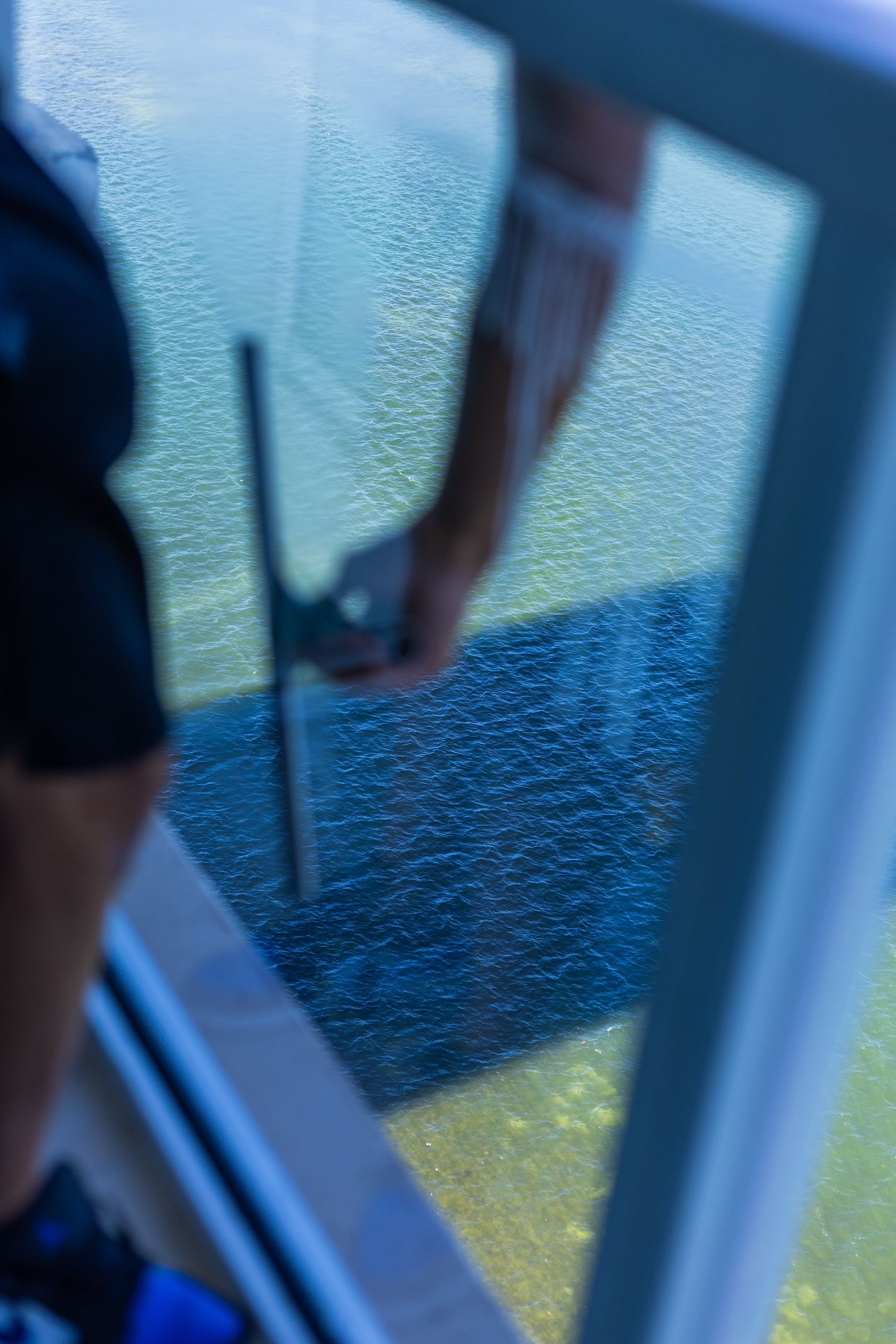 Professional window cleaner washing exterior windows of a stunning modern glass home in South Florida