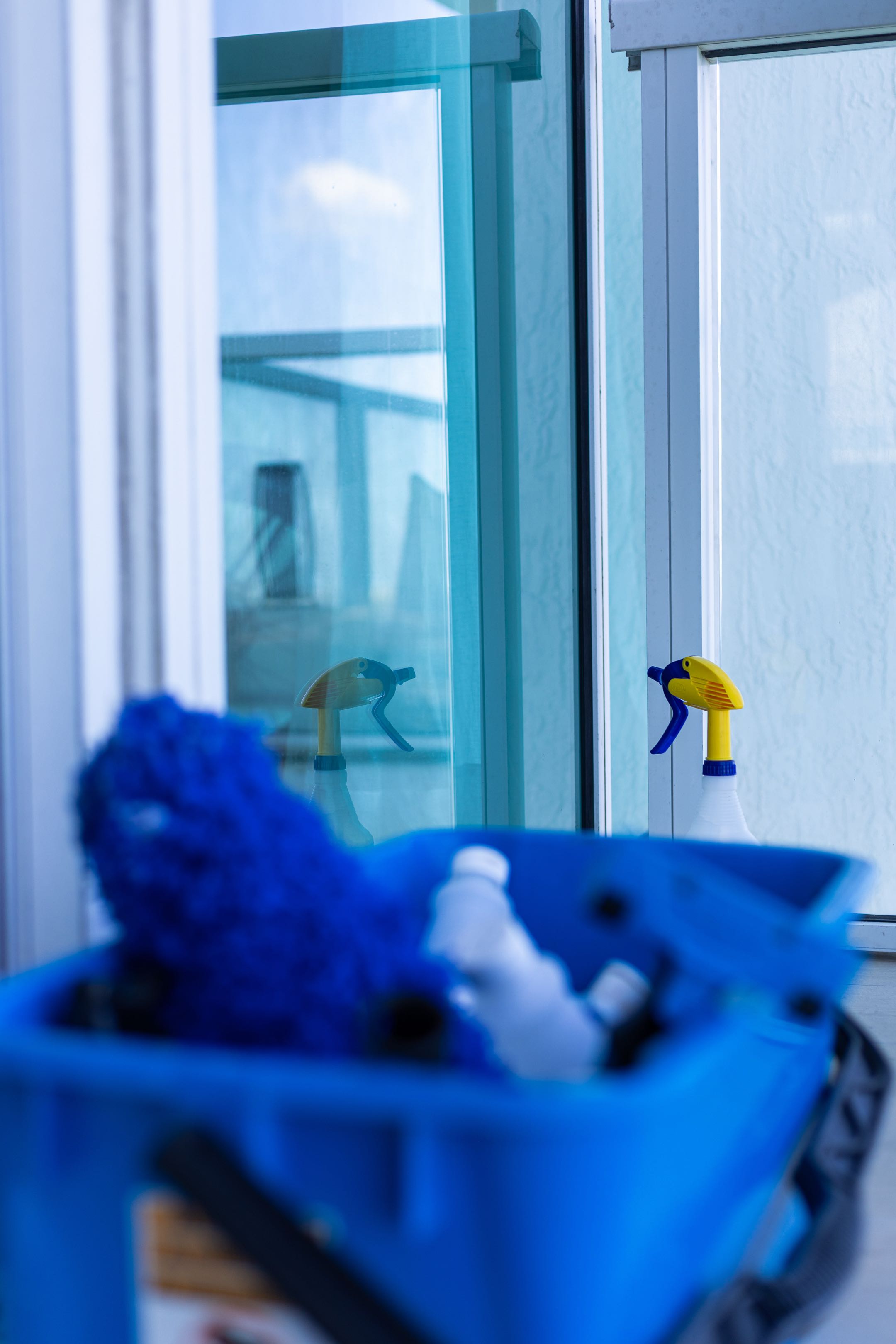 Professional window cleaner washing large glass windows with modern squeegee equipment