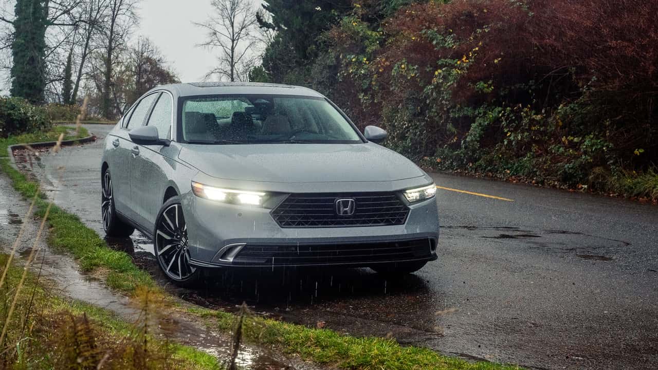 11th generation Honda Accord sedan (2023-2025 model) parked on scenic Maine road at golden hour showcasing distinctive modern redesigned exterior with sleek LED headlights and refined silhouette