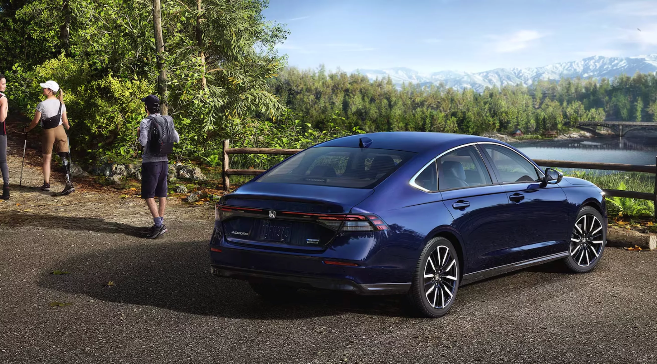 11th generation Honda Accord sedan (2023-2025 model year) with distinctive modern redesigned styling featuring sleek horizontal LED headlights, refined grille, and elegant body lines driving through beautiful Maine scenery on a clear day with lush green landscape