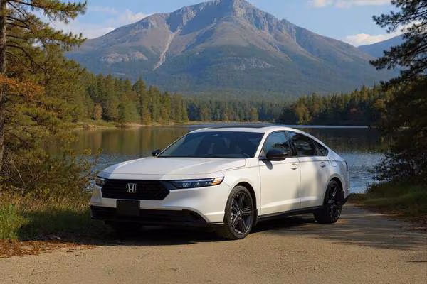 11th generation Honda Accord sedan (2023-2025 model) cruising through the scenic Kennebec Valley Maine countryside with rolling hills and autumn foliage in the background