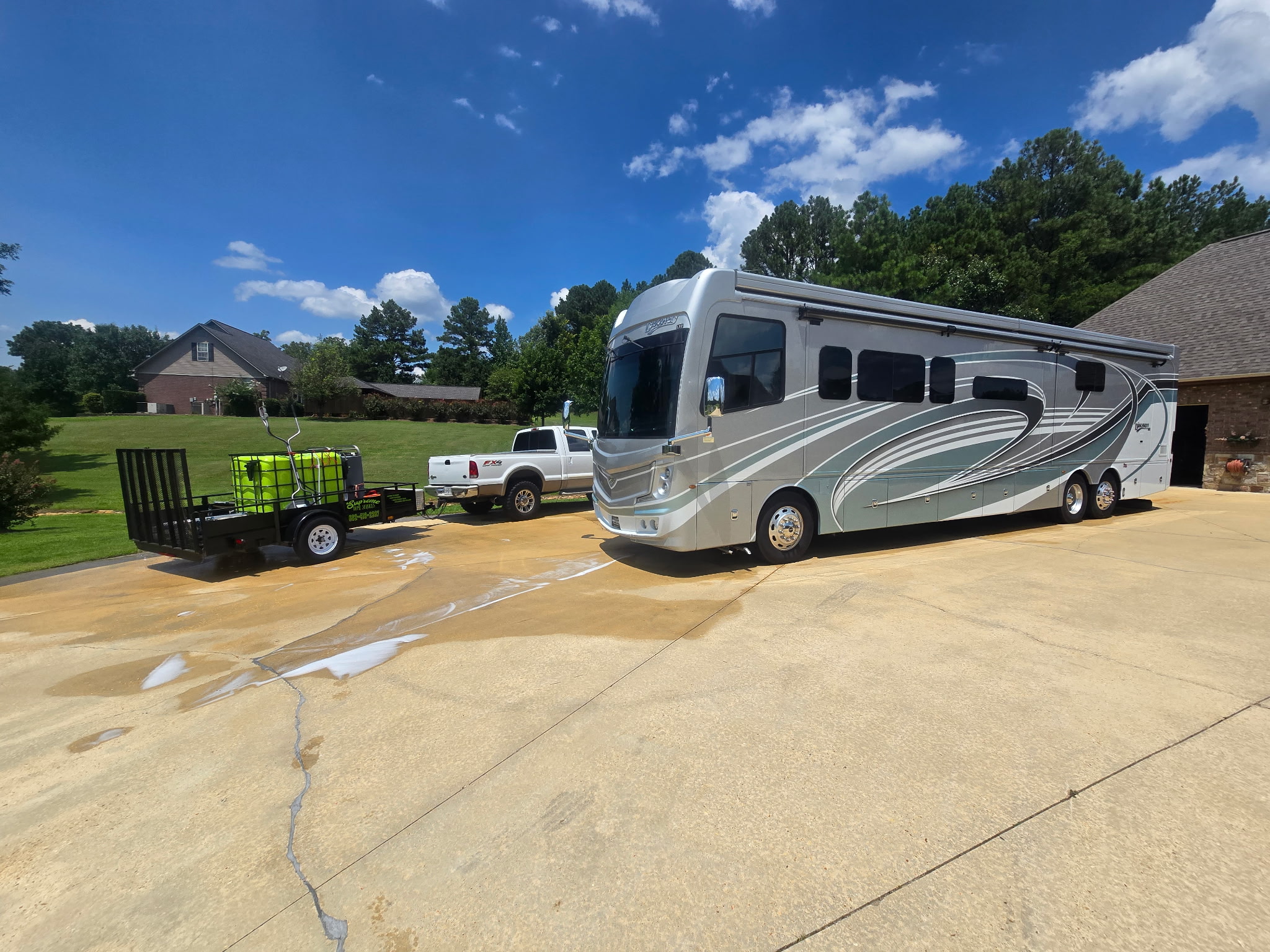 Professional pressure washing of large RV motorhome exterior showing spotless clean finish