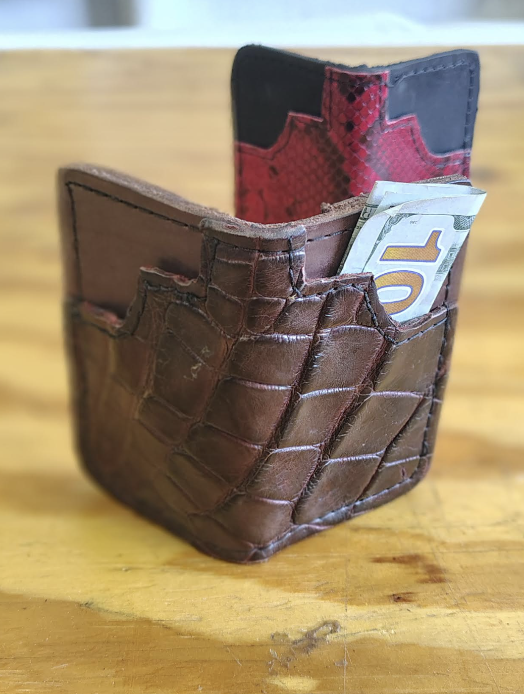 Handcrafted brown leather bifold wallet with hand-stitched edges