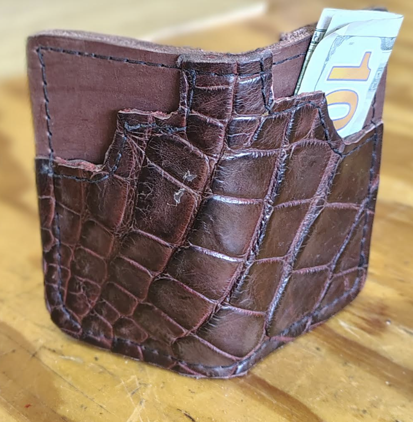 Vintage tan leather trifold wallet with brass hardware