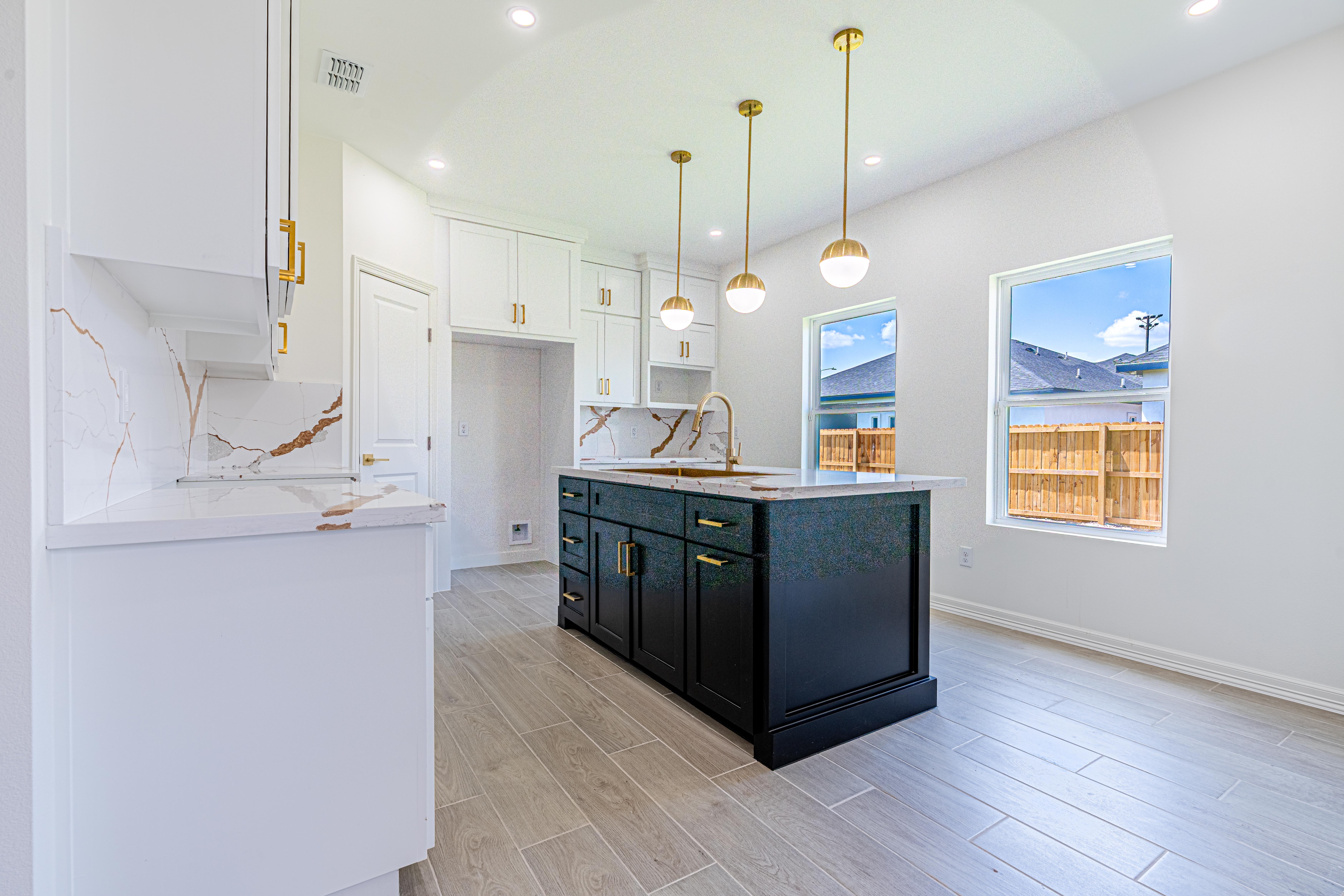 Kitchen and dining area with white cabinets, marble backsplash, and large-format tile