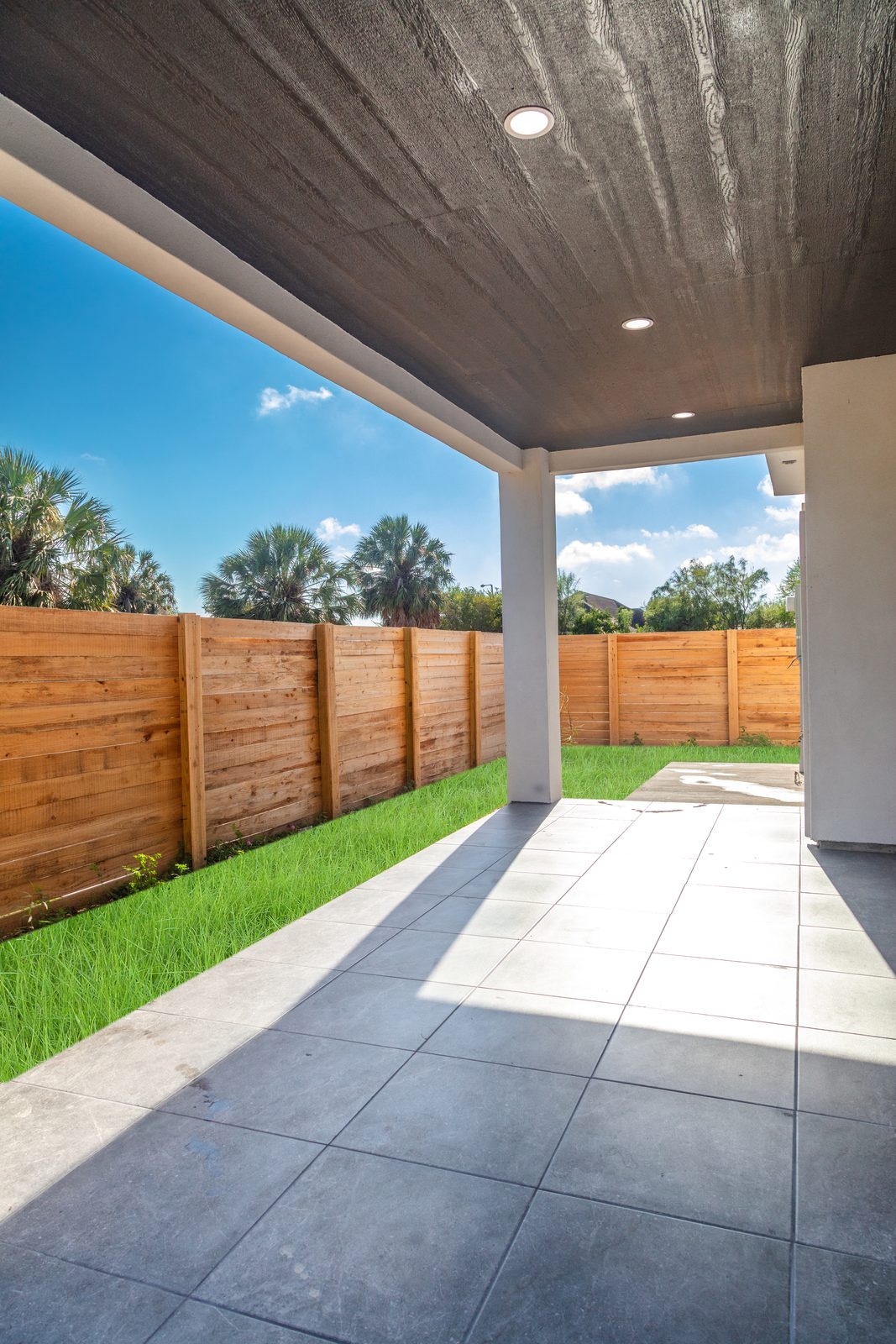 Covered rear patio with privacy fence