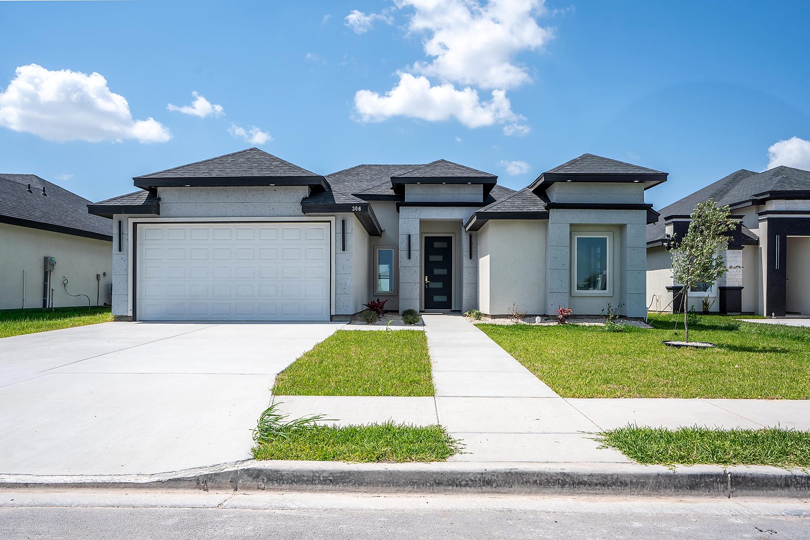 Gray stucco home exterior with dark trim