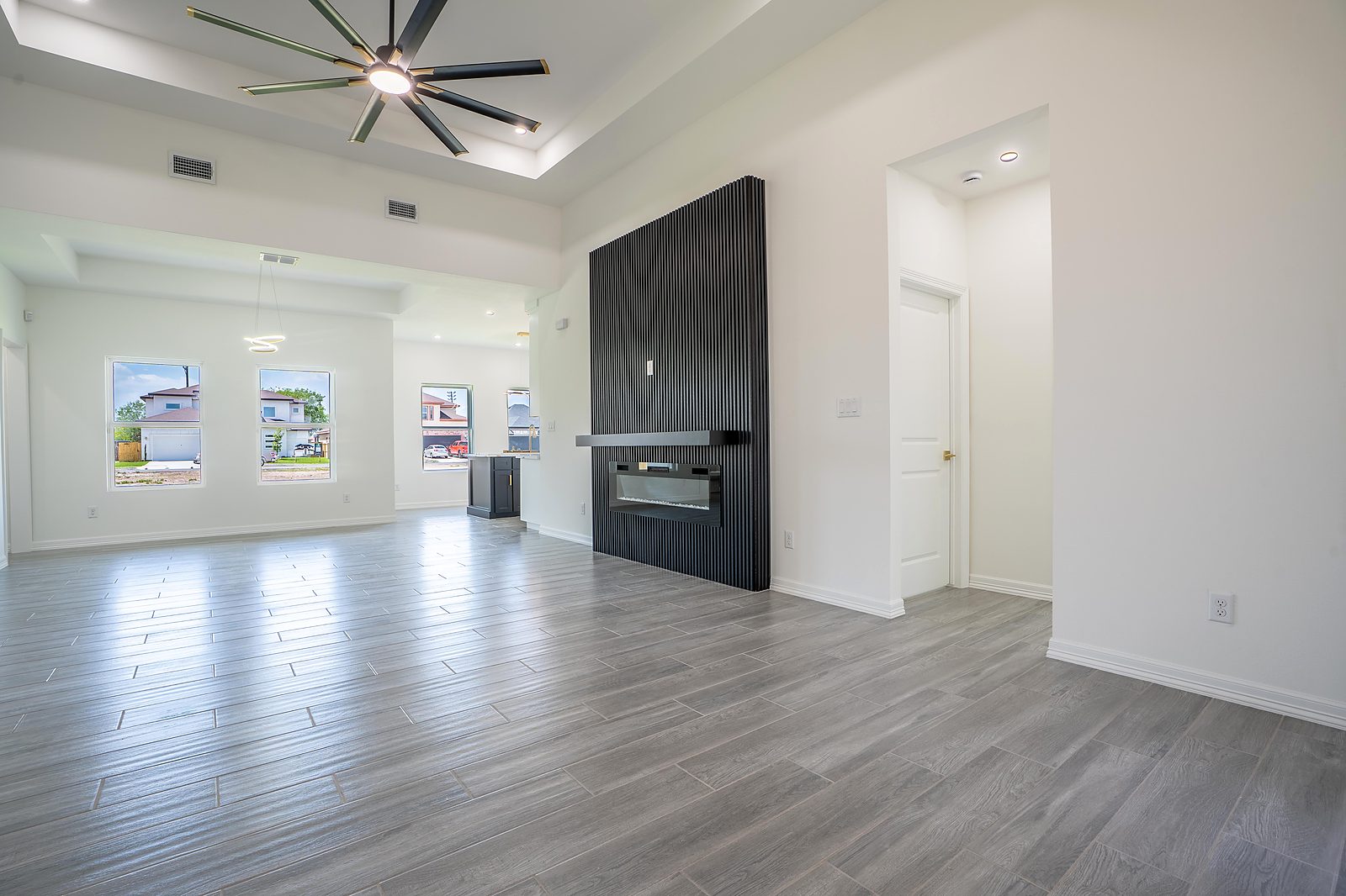 Living room with slat wall feature and linear fireplace