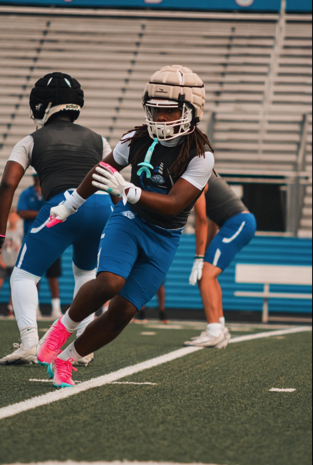 Wide receiver making a spectacular one-handed catch during a night game