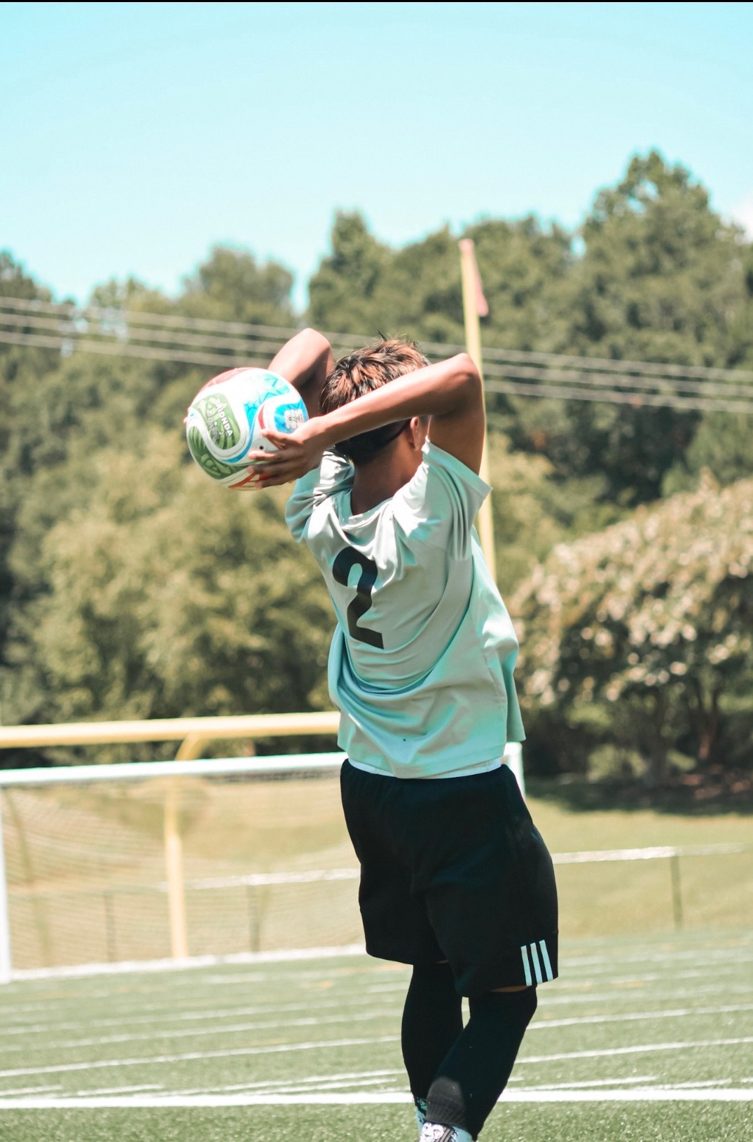 Explosive football tackle captured mid-air showing raw power and intensity between two players