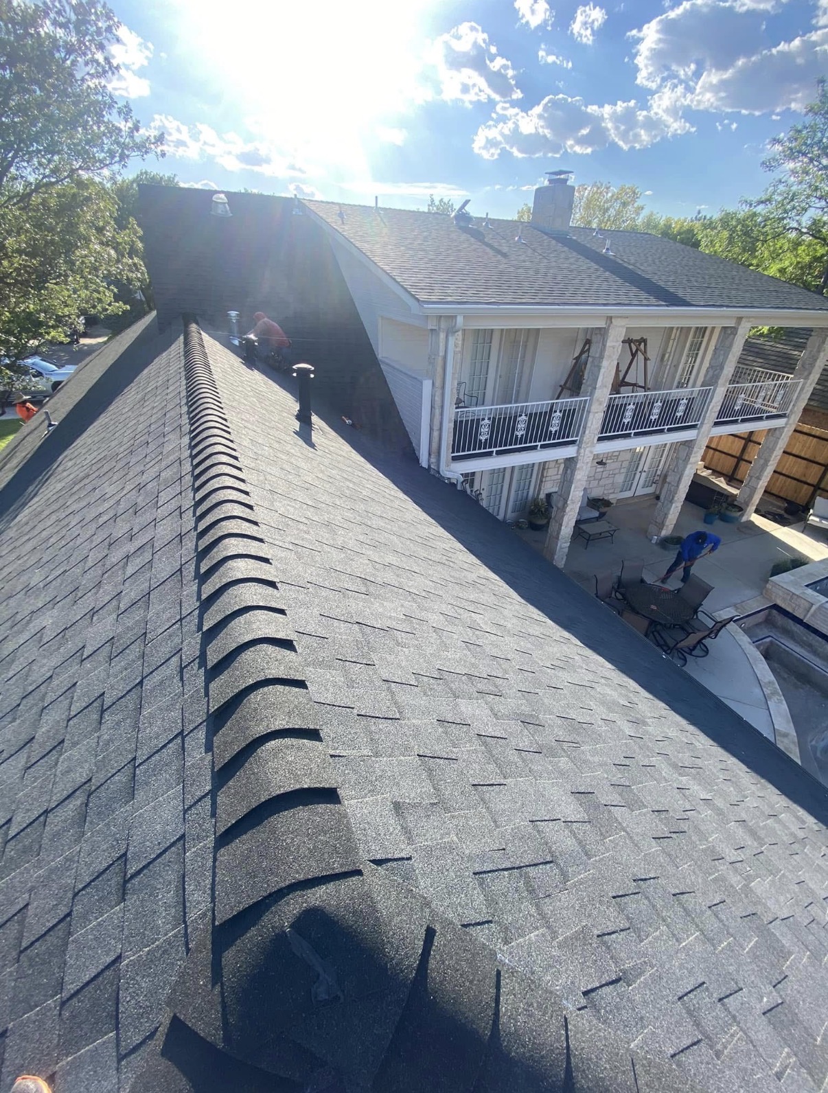 Najera Roofing team inspecting a newly installed roof with safety gear