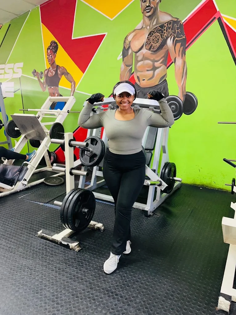 Dedicated weight training area with barbells, squat racks, and heavy lifting platforms