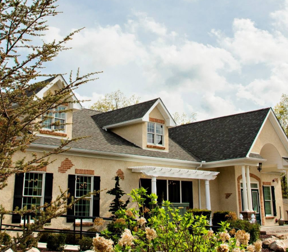 Sand Springs community clubhouse exterior with stone architecture and landscaping