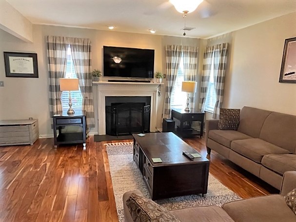 Sunlit open-concept living room with vaulted ceilings and modern neutral furnishings in luxury townhome