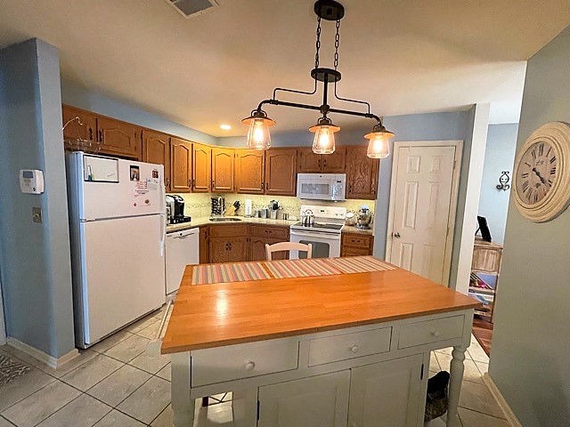 Chef kitchen with quartz island custom cabinetry and stainless appliances in upscale townhome