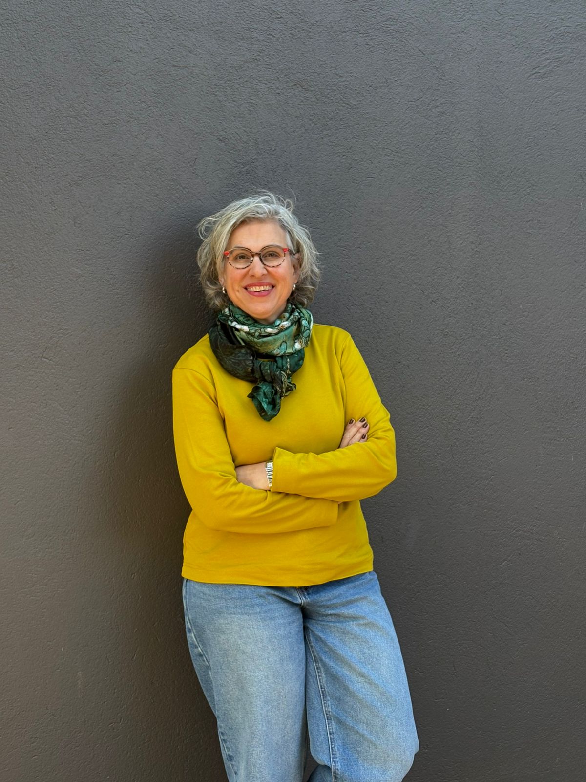 Professional medical portrait of Dr. Stols, female founder and main practitioner, wearing a white coat in a modern clinical setting