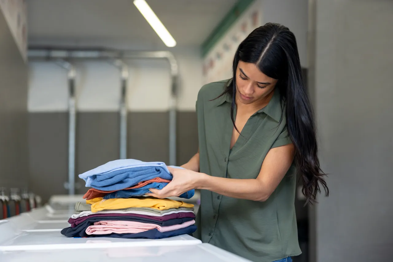 Fresh clean laundry tumbling inside modern washing machine
