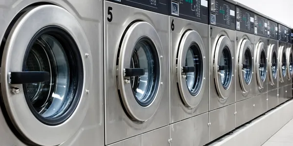 Spotless modern laundromat with premium stainless steel washing machines in Washington Heights