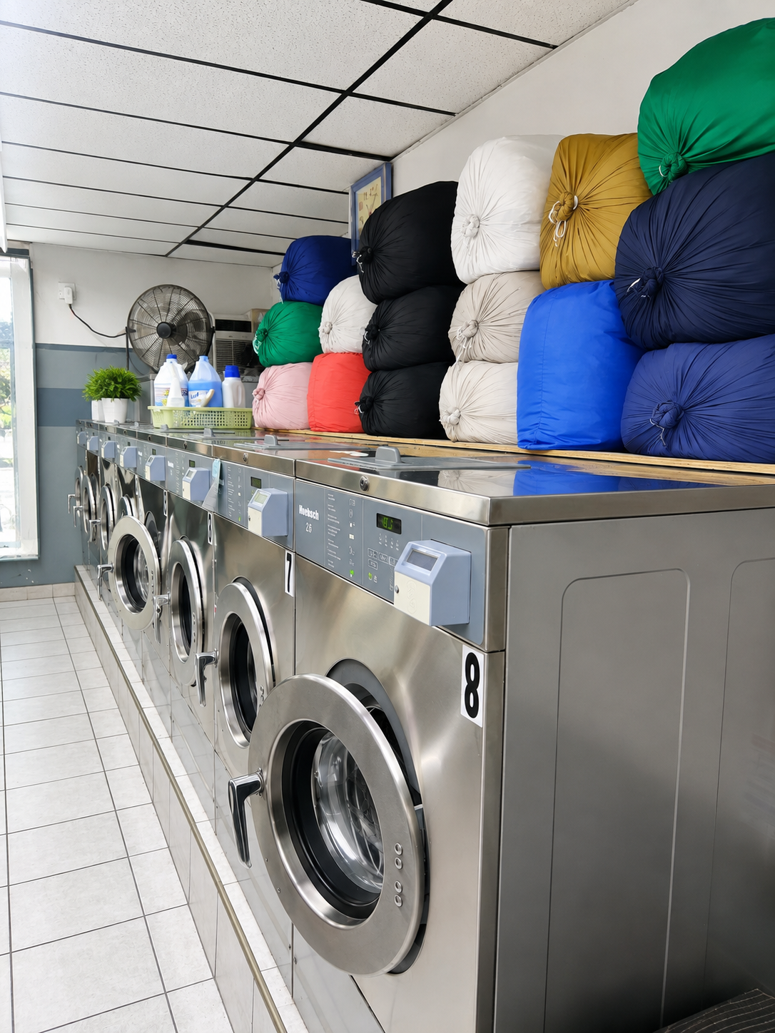 Modern eco-friendly detergent station with premium laundry products in bright laundromat