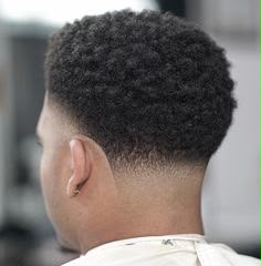 Sharp skin fade haircut with textured top on male client at Ambassador Barber Shop Calgary