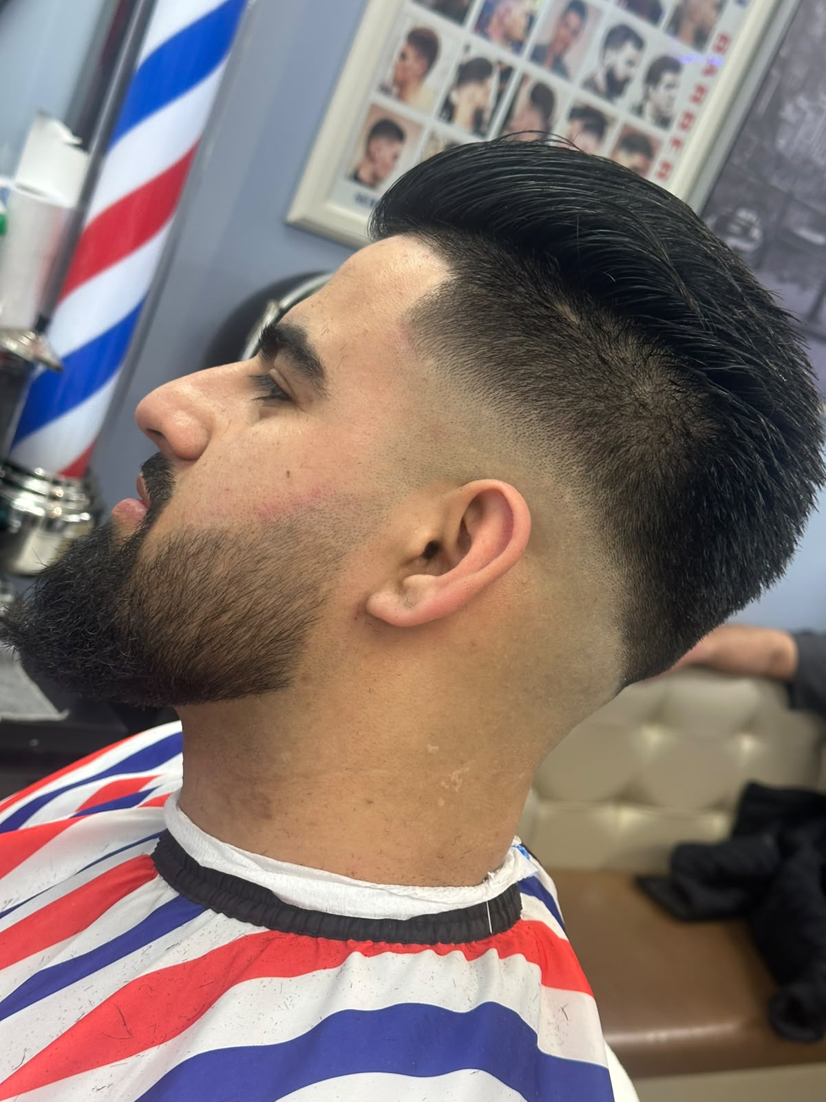 Full beard shaping and straight razor detailing on bearded client at Calgary barbershop
