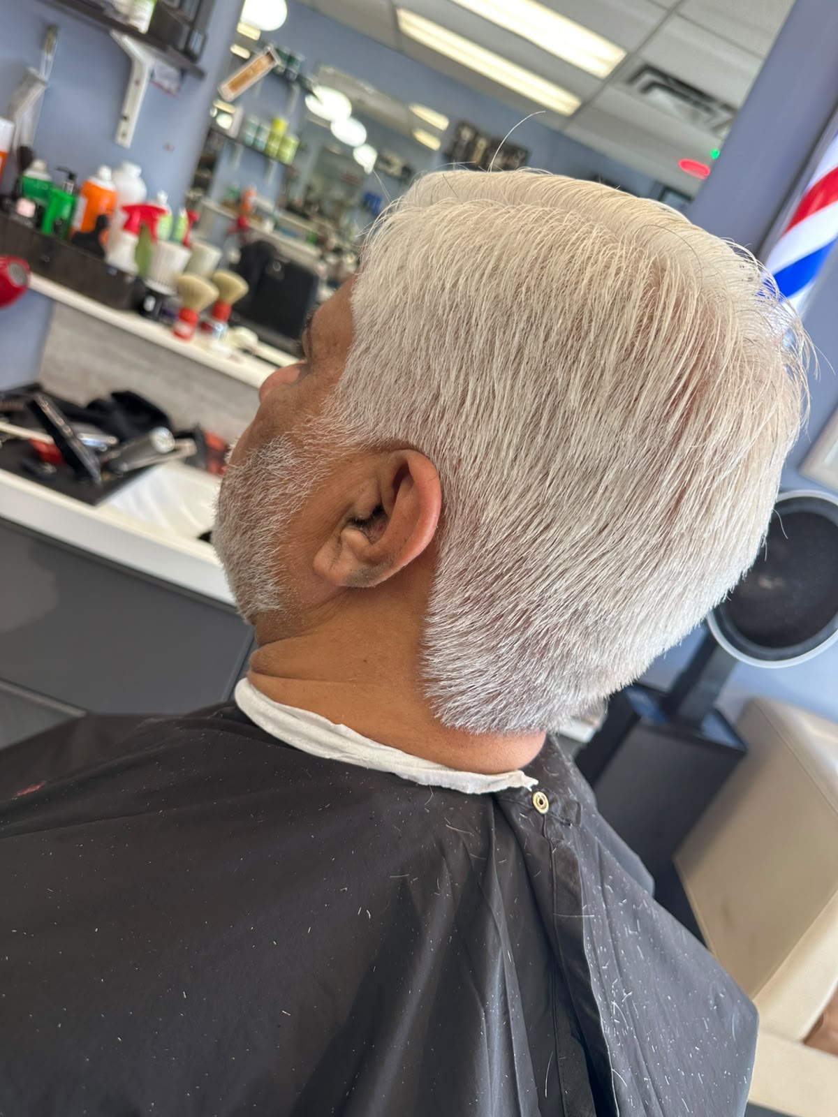 Classic pompadour haircut styled high and glossy at Ambassador Barber Shop Calgary