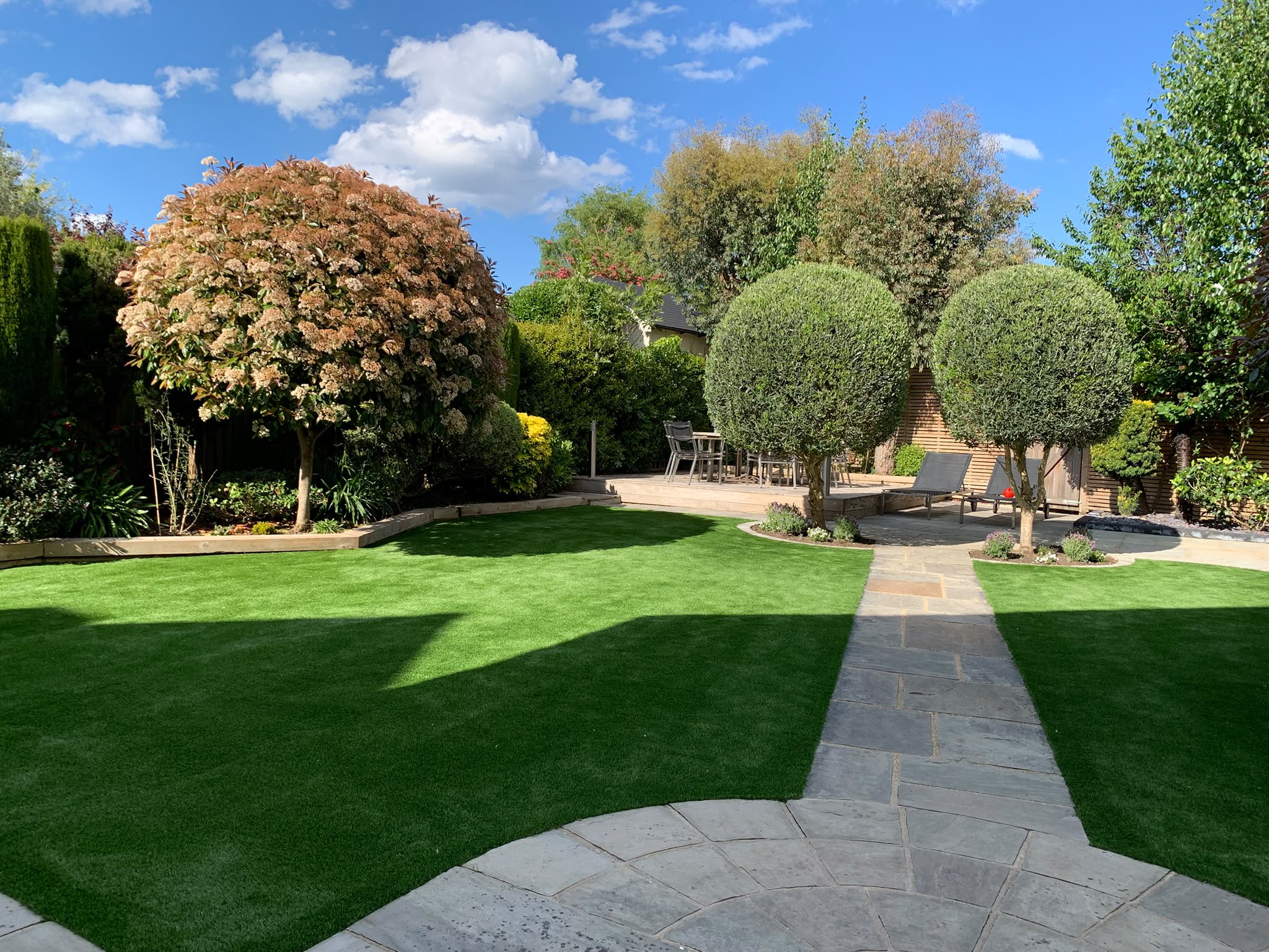 Beautifully landscaped garden with vibrant green lawn and manicured hedges