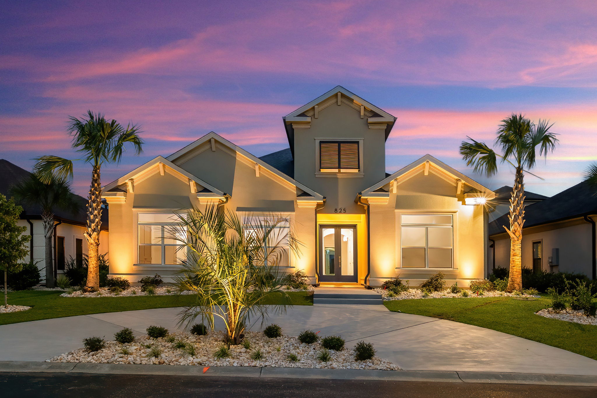 Luxury coastal home with subtle architectural uplighting at twilight