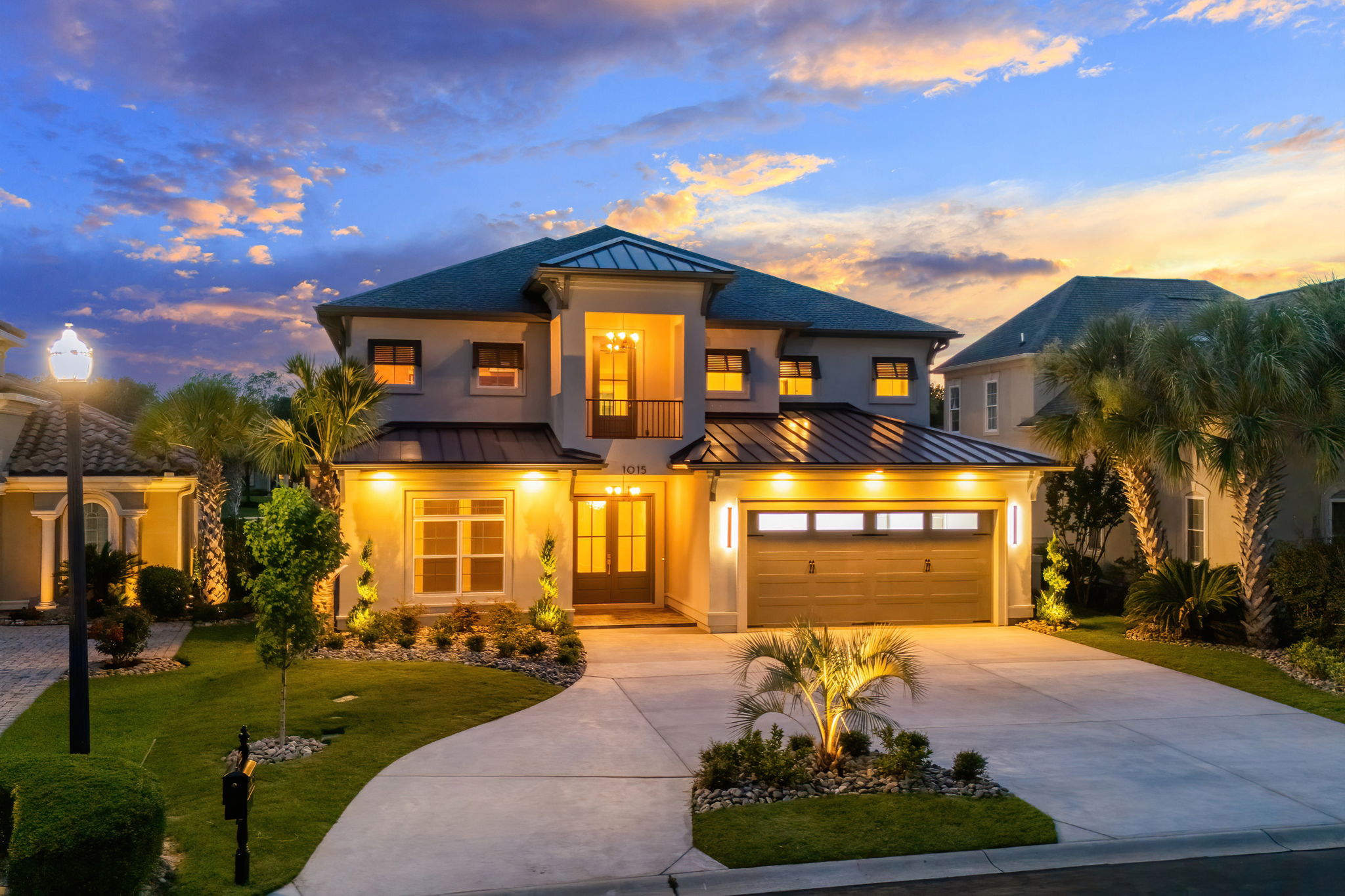 Illuminated coastal home exterior with warm architectural lighting