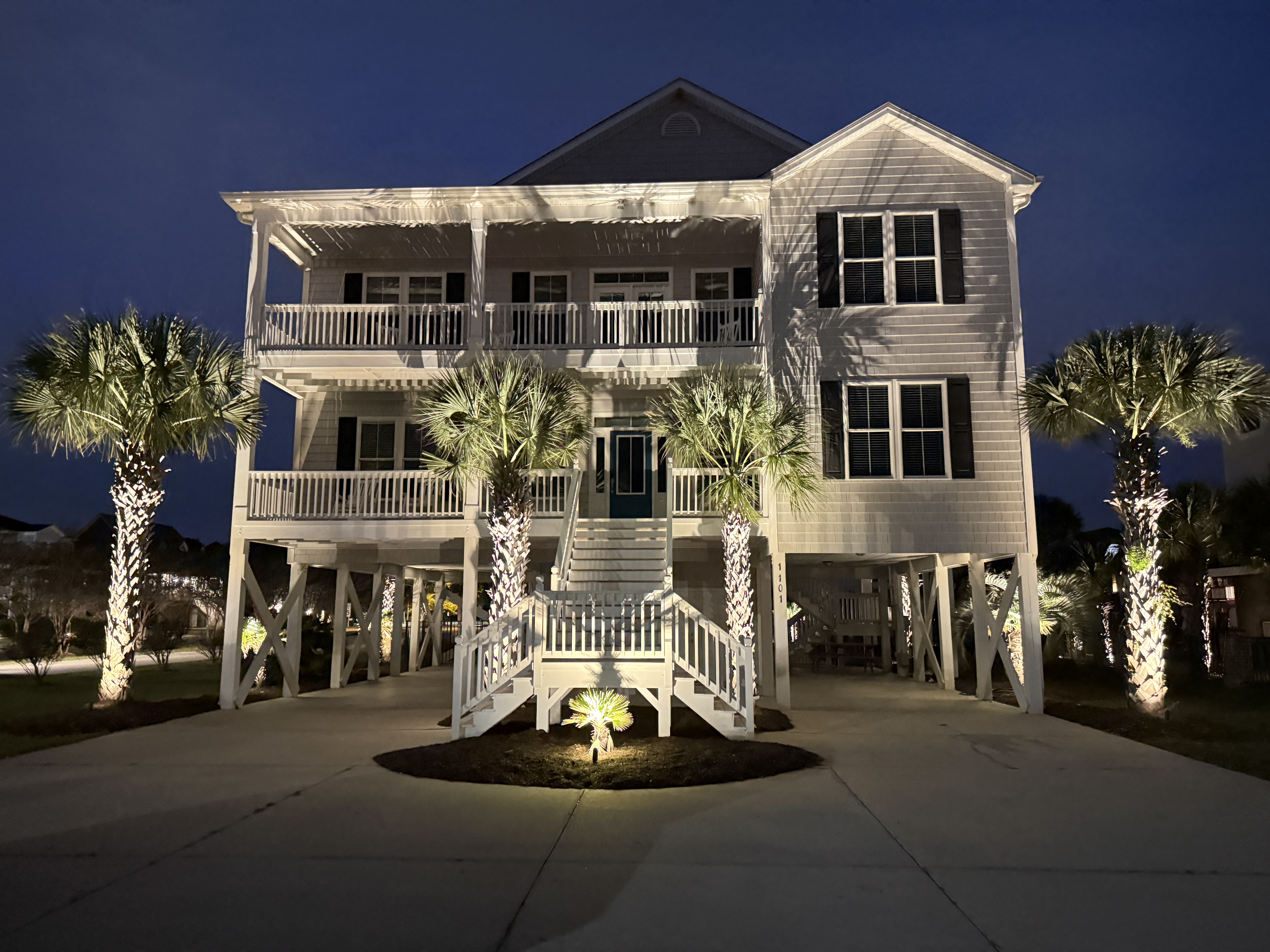 Natural stone stairway with subtle step lighting descending to beach access