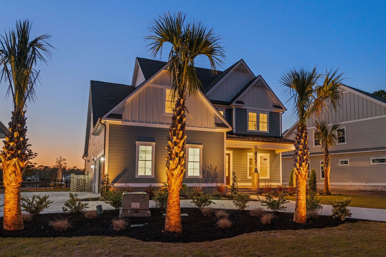 Fully equipped outdoor kitchen with dedicated task lighting over grill and countertops