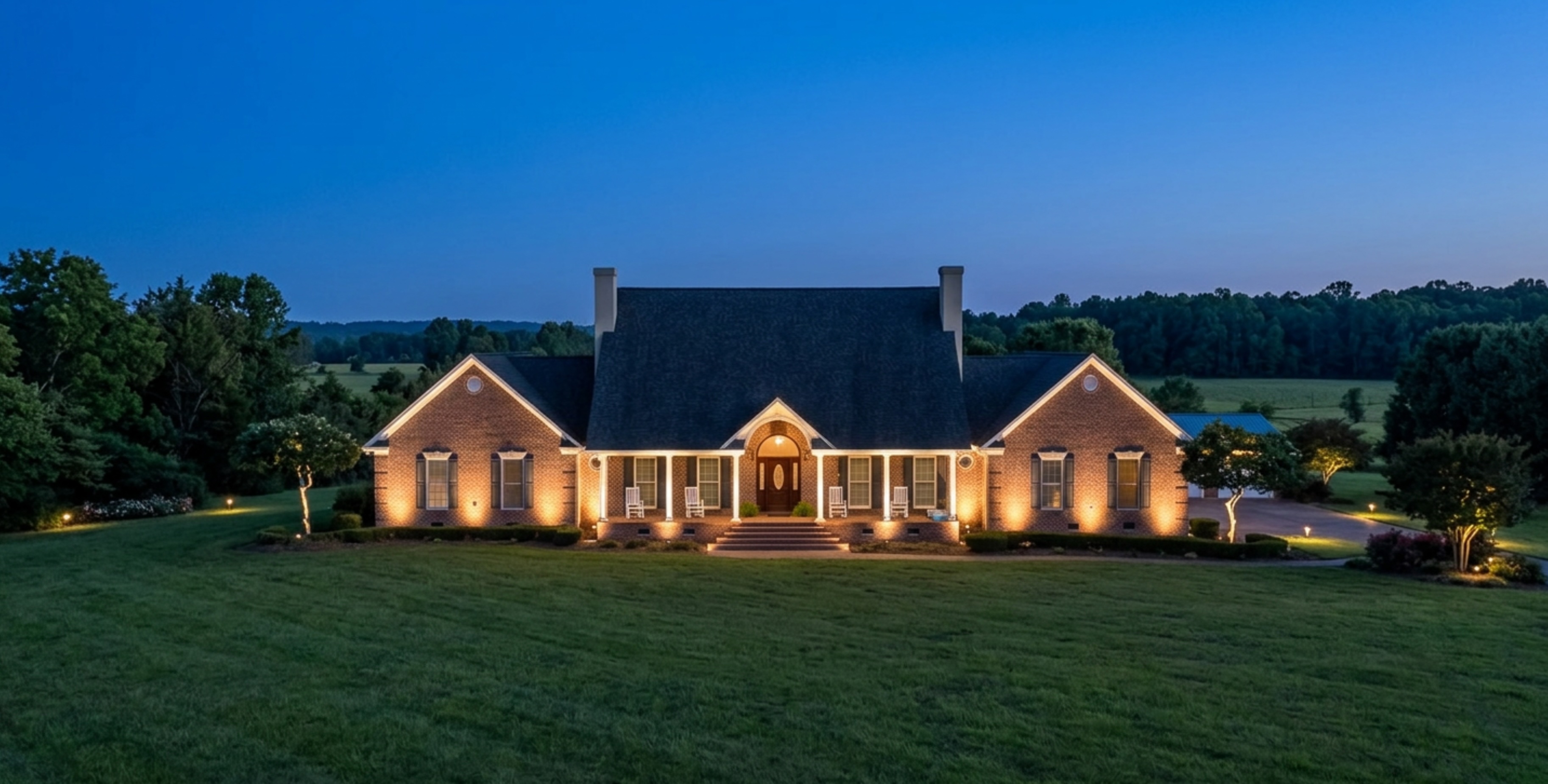 Ornamental garden bed with layered lighting on hydrangeas and coastal grasses