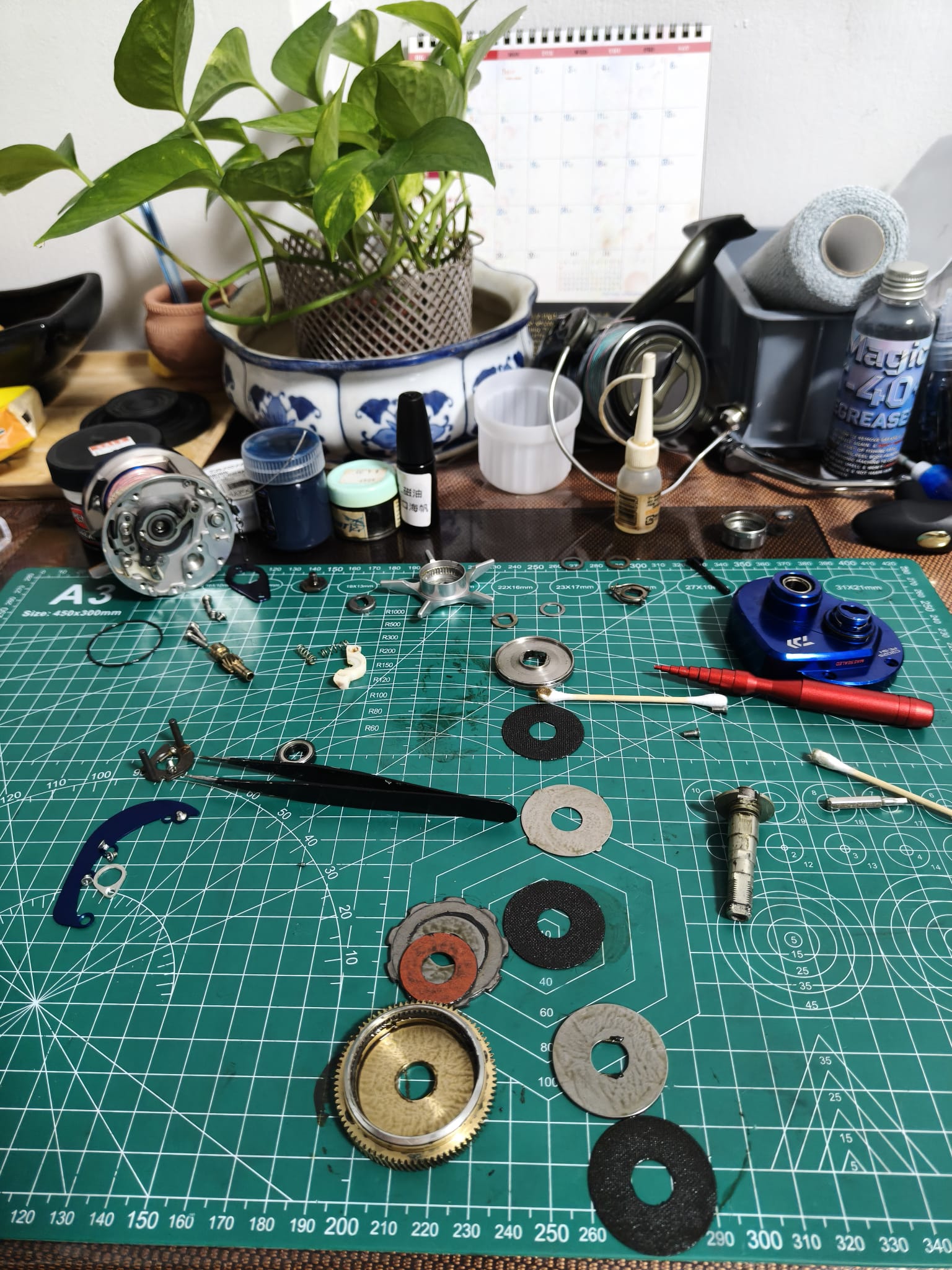 Tony performing full strip-down cleaning on a Daiwa saltwater fishing reel at Tony's Tackle Singapore workbench