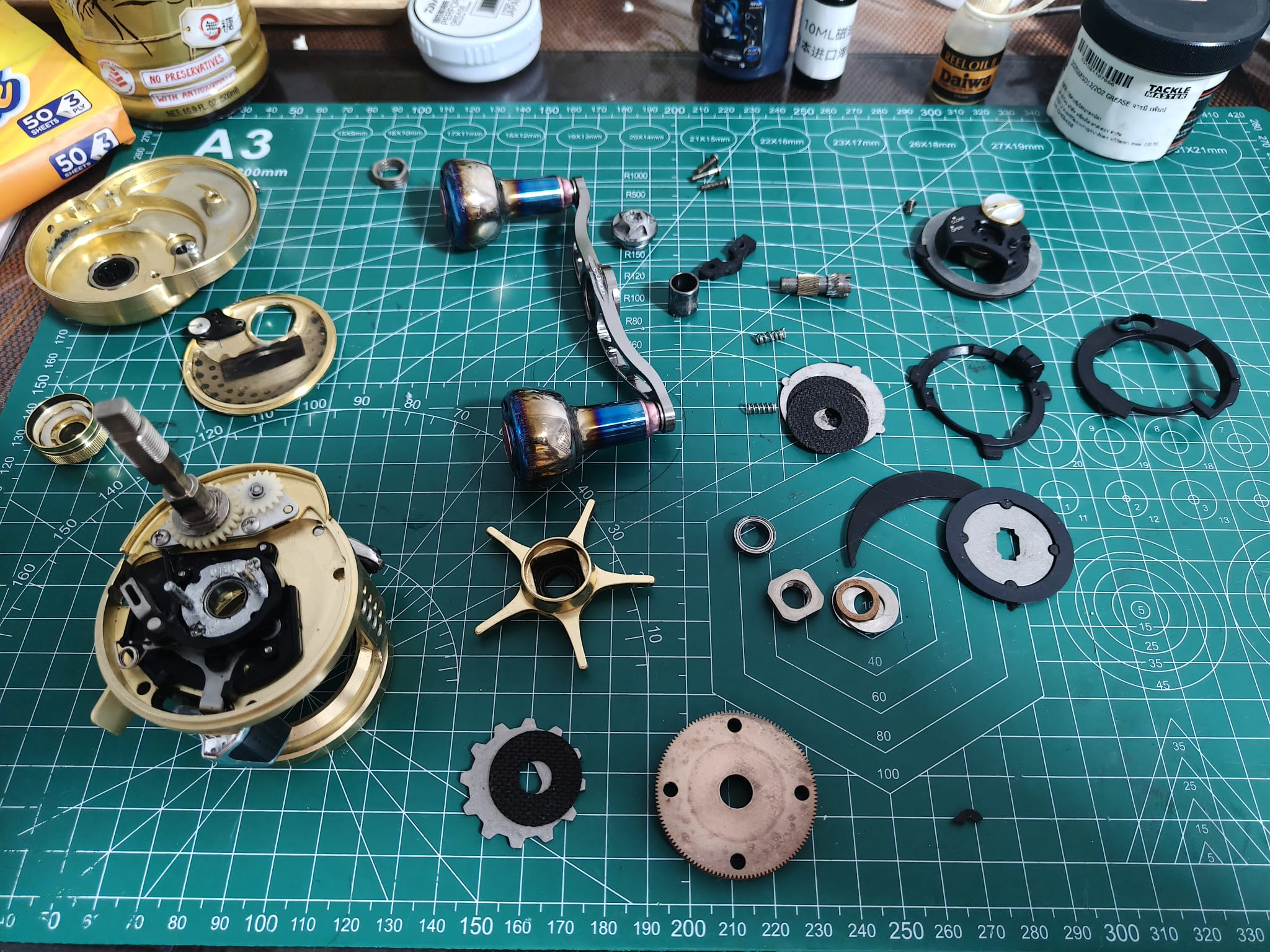 Custom drag system rework and carbon washer upgrade on high-end jigging reel at Tony's workshop