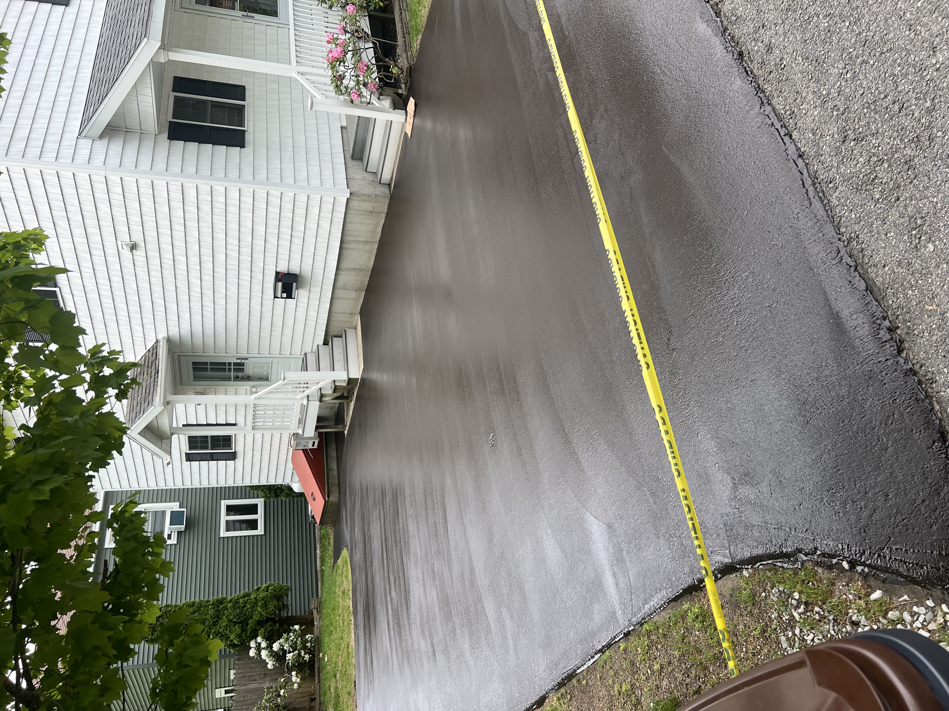 Freshly paved residential asphalt driveway with crisp clean edges in Maine