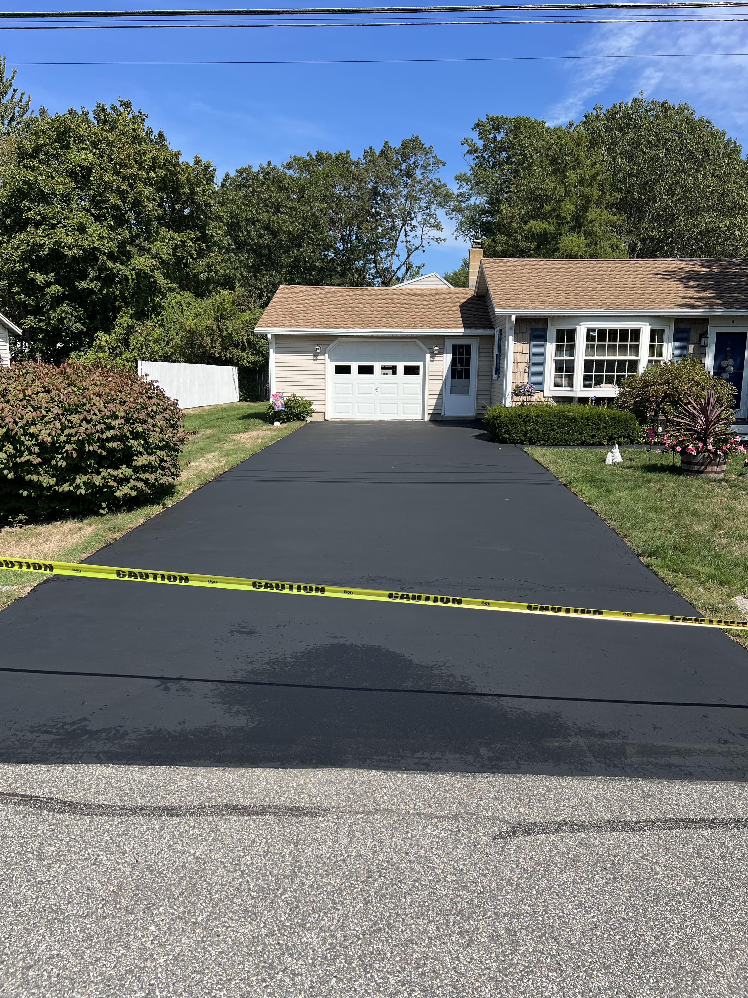 Crack sealing and patchwork repair on commercial asphalt surface