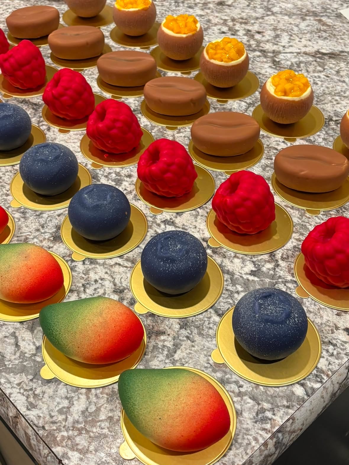 Freshly baked artisanal fruit pastries, tarts, and croissants made with organic fruits on an elegant display