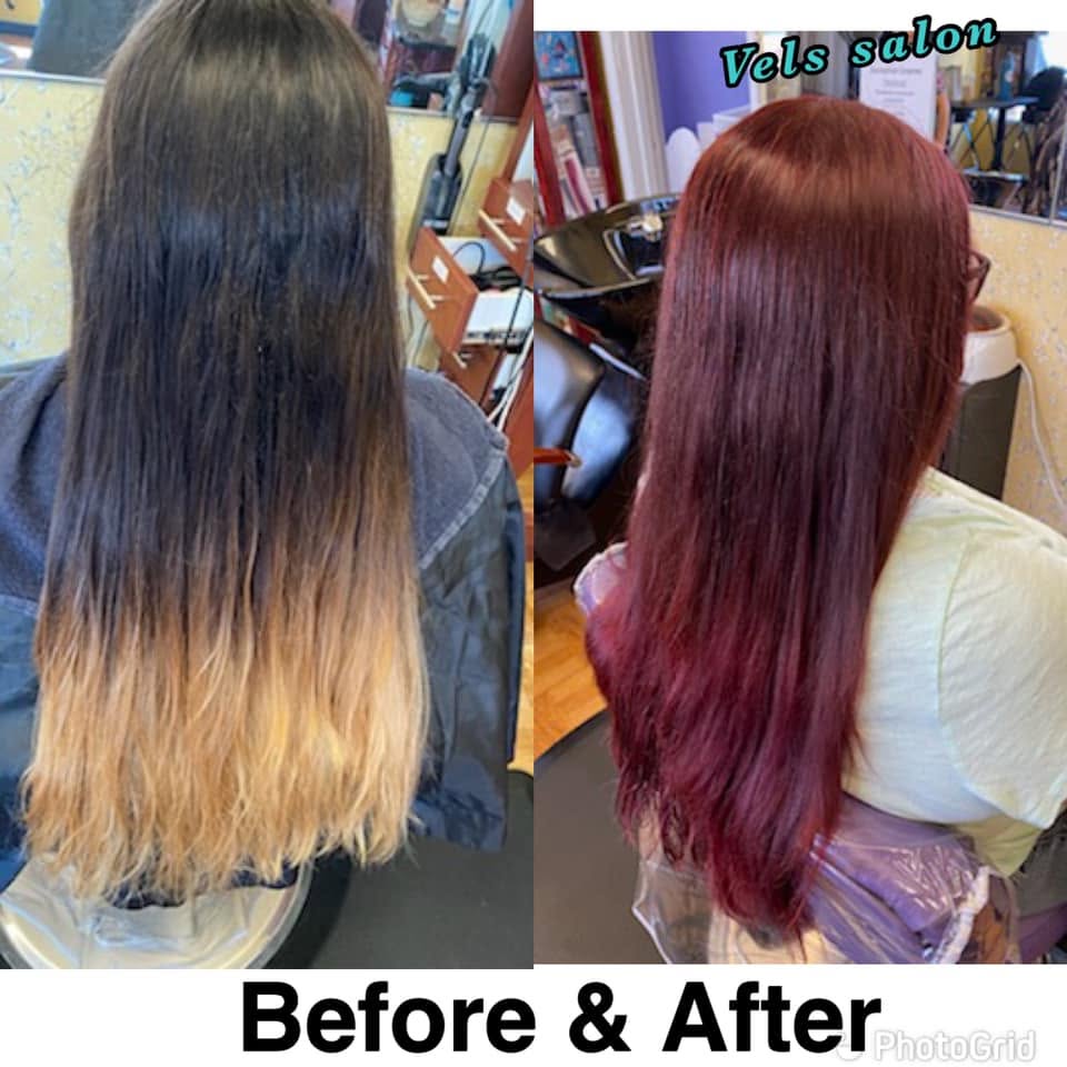 A woman with long, wavy hair showcasing a beautiful and subtle balayage color treatment