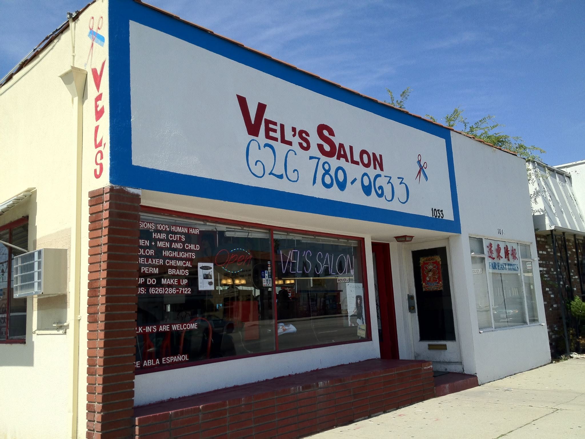 Professional stylist providing a haircut in a warm, elegant salon environment in San Gabriel