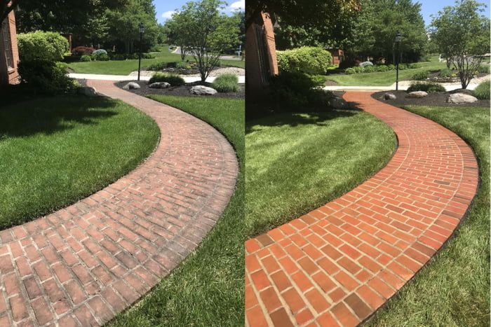 A clean, freshly pressure-washed concrete driveway, half clean and half dirty to show contrast