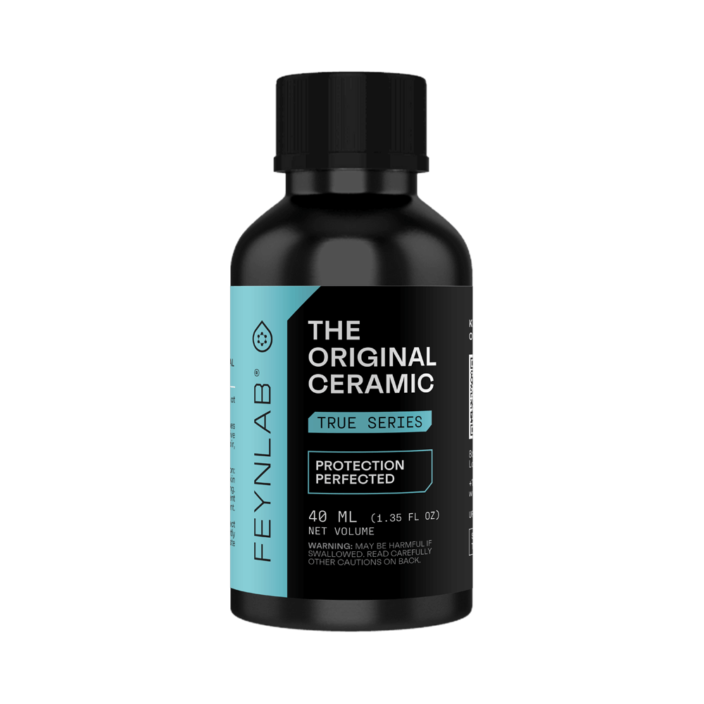 Feynlab Original Ceramic Coating bottle displayed on a dark luxury car hood with deep gloss reflection