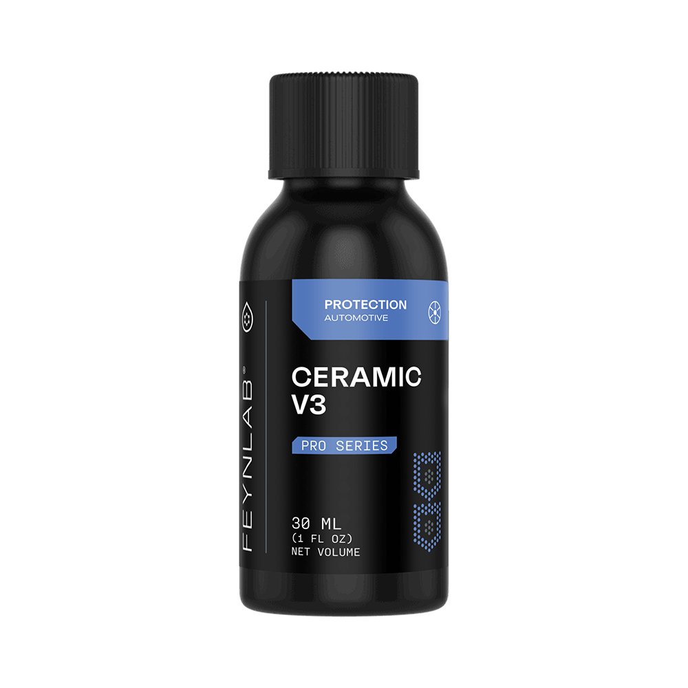Feynlab® Ceramic V3 premium hydrophobic coating creating intense water beading on a glossy black painted vehicle surface