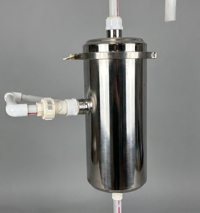 A compact and modern under-sink residential water filtration system with chrome fittings