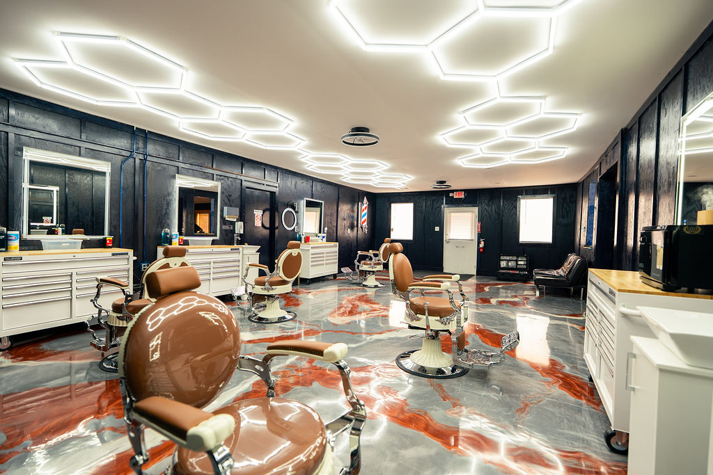 Interior of Blessed VIP Cutz showing modern luxury barber stations and premium leather chairs
