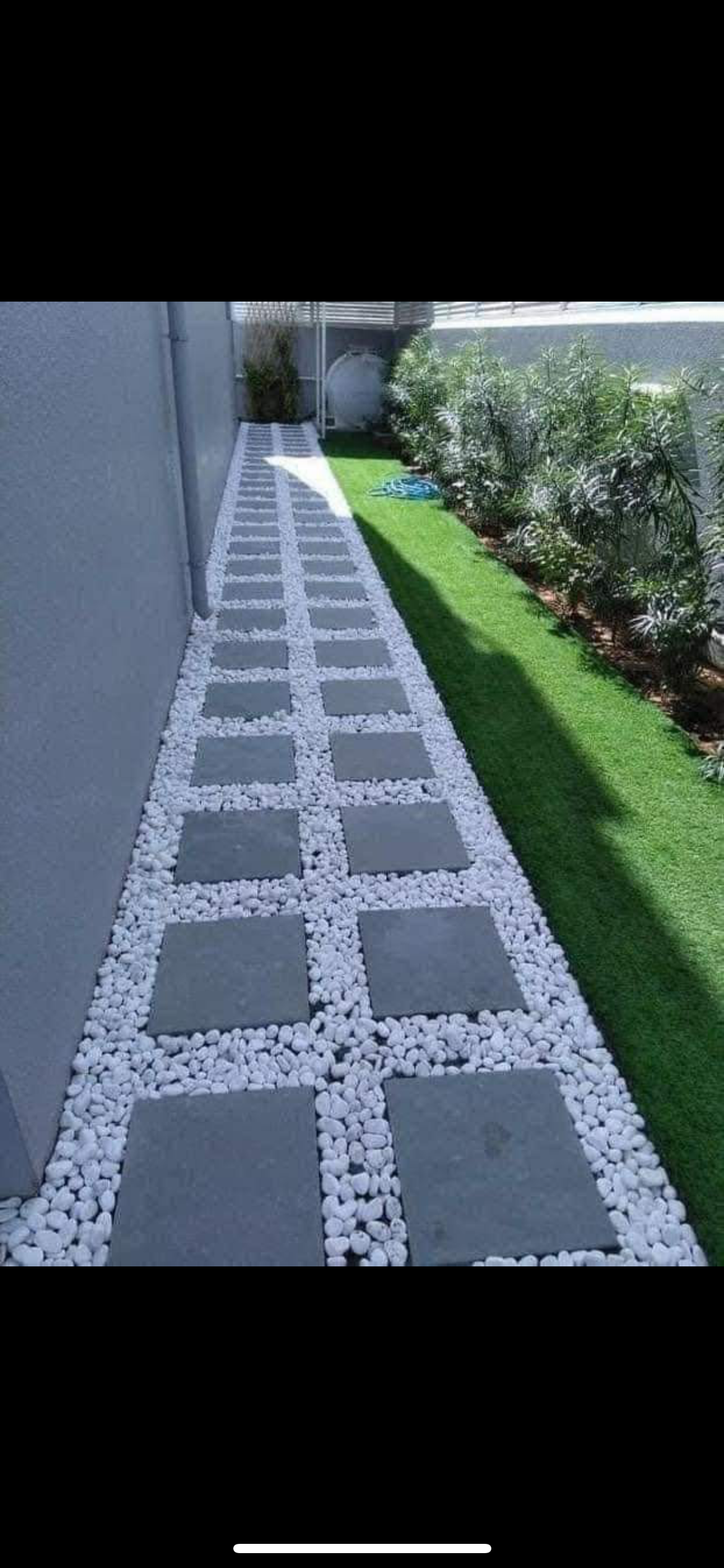 Elegant natural stone hardscape walkway winding through manicured garden landscape