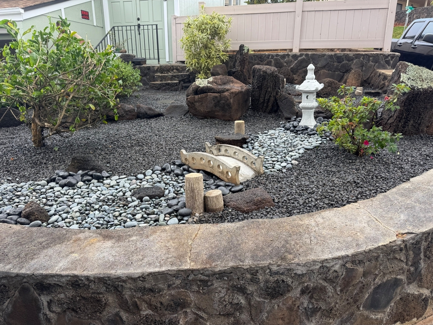 Tropical palm tree landscaping design with layered greenery and decorative rocks